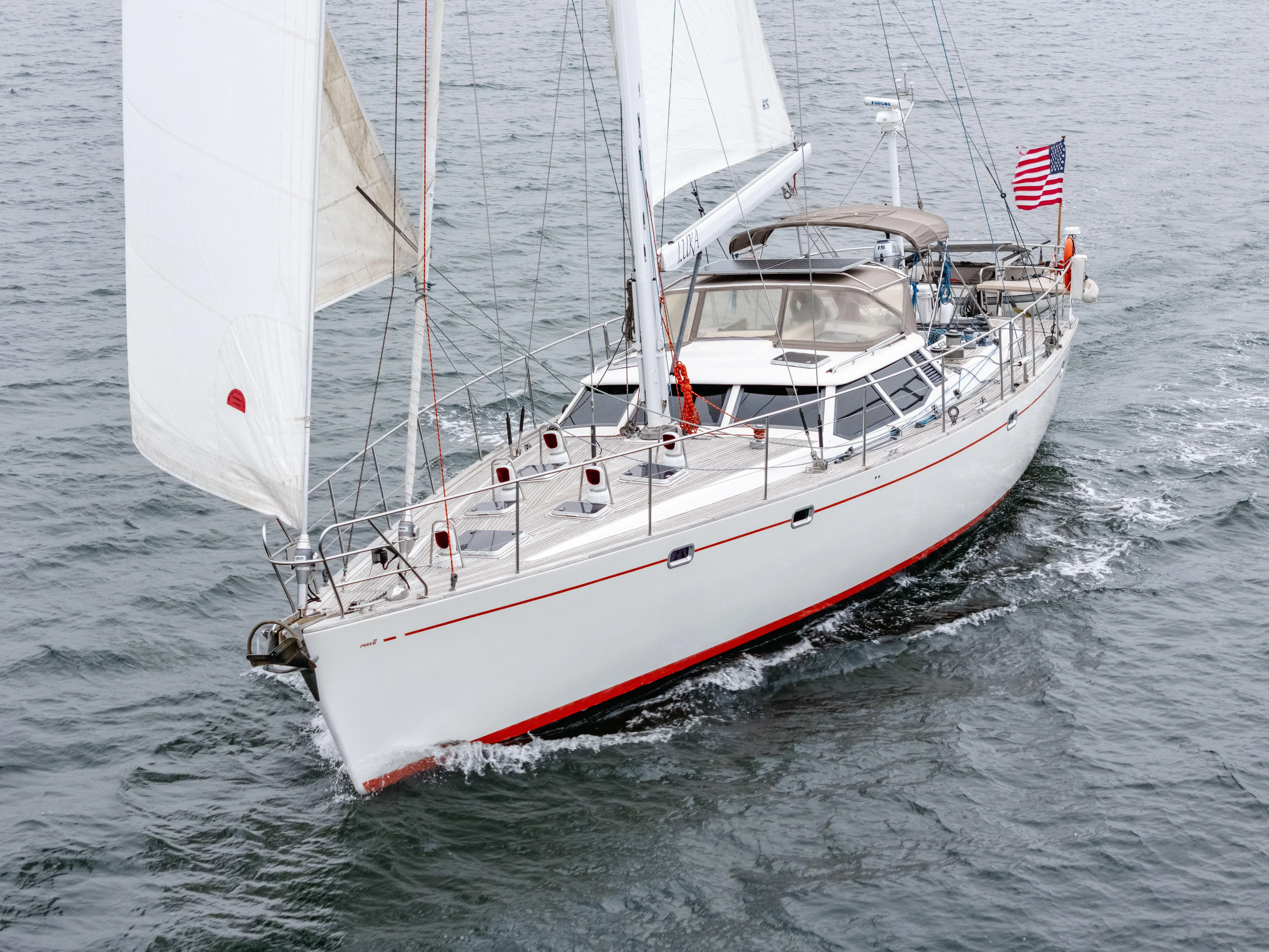 Luka Yacht Photos Pics Sailing yacht Farr 60 Pilot House 1997 on open water with American flag.
