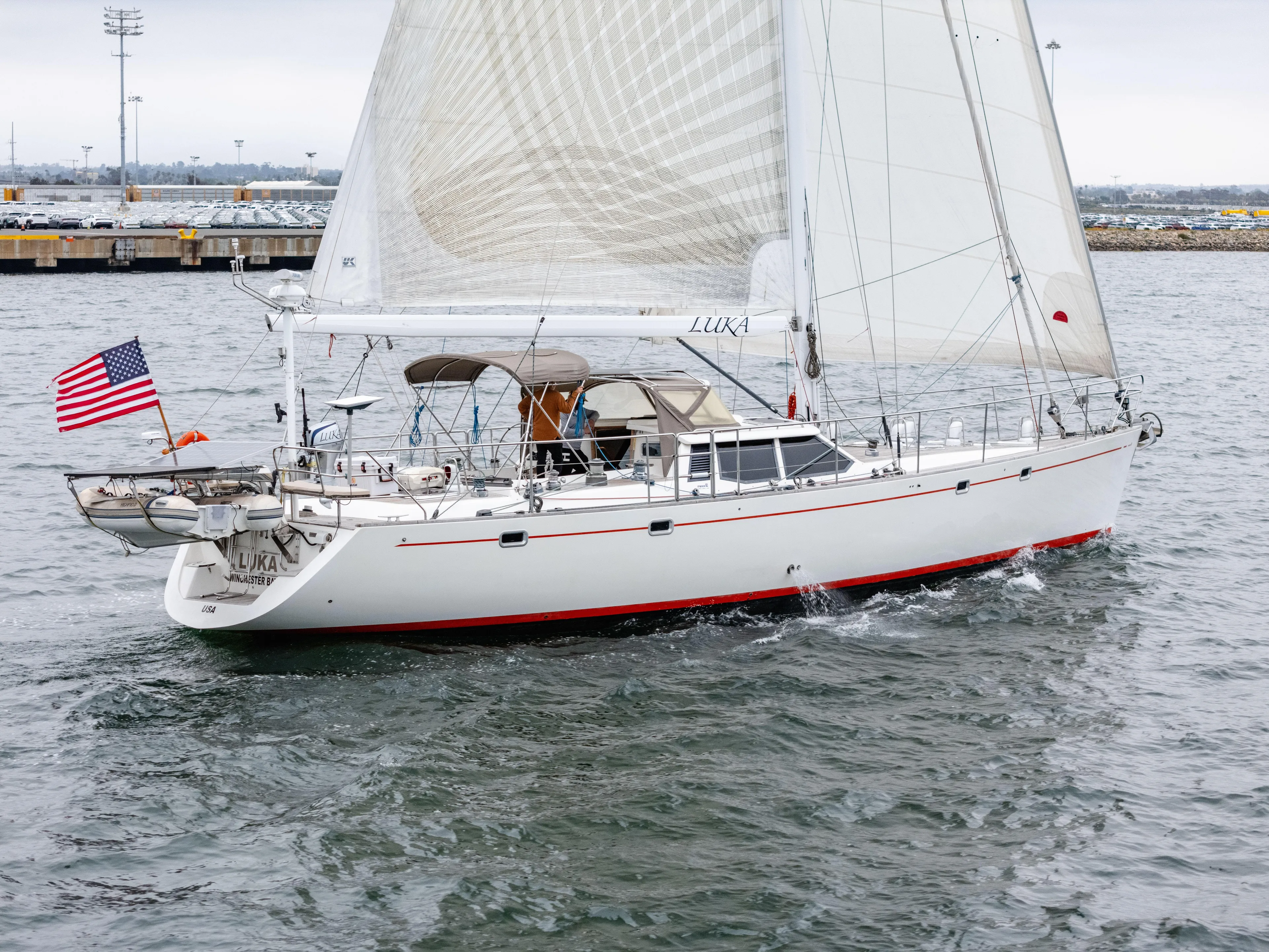Luka Yacht Photos Pics Sailing yacht Farr 60 Pilot House, 1997 model, cruising with American flag in harbor.