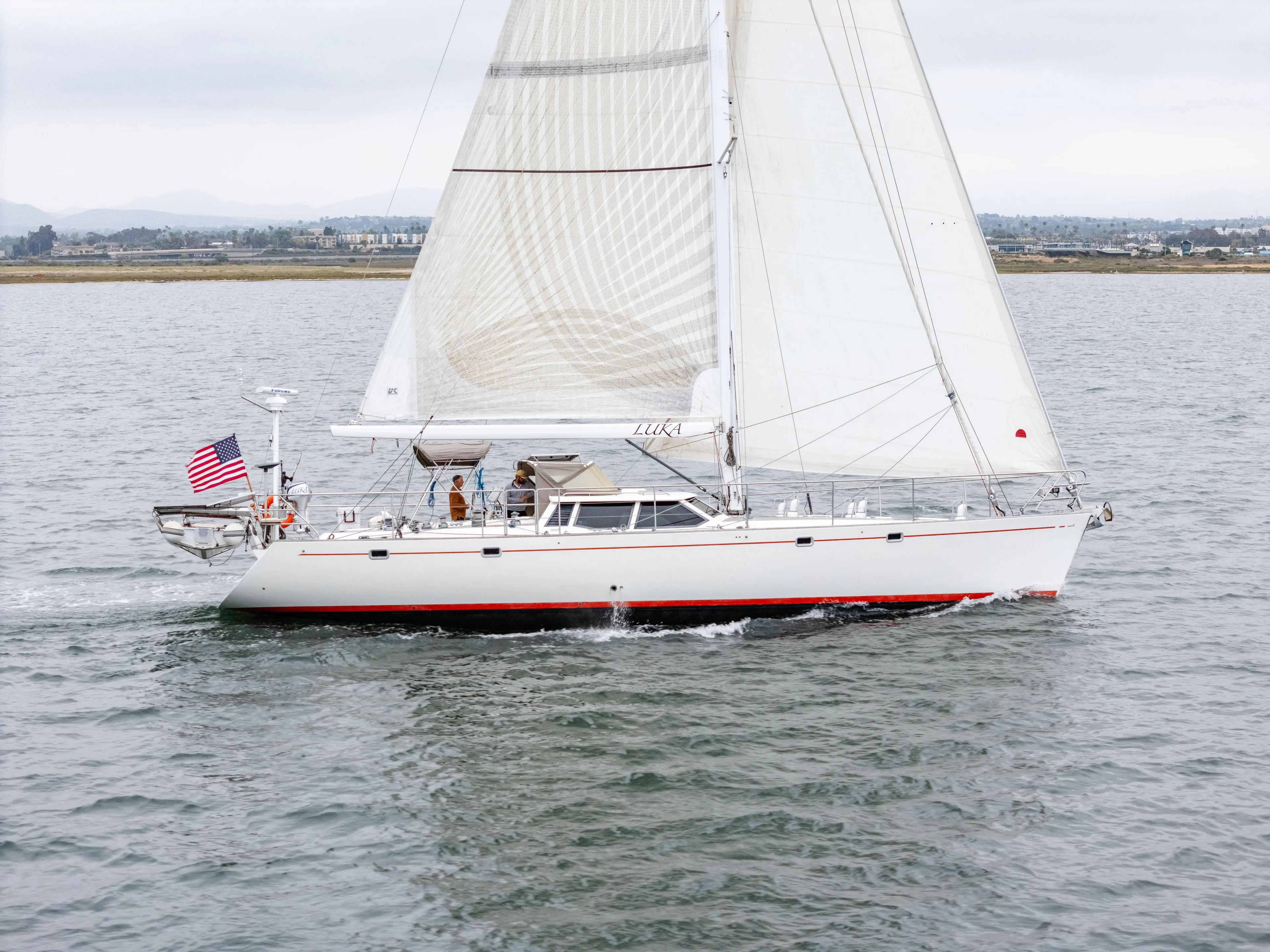 Luka Yacht Photos Pics Sailing yacht Farr 60 Pilot House 1997 on open water, white sails, American flag.
