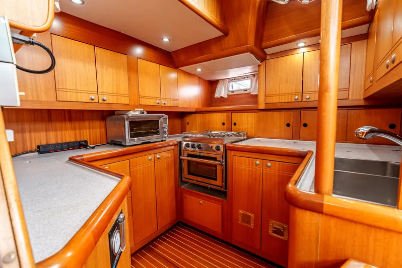 Luka Yacht Photos Pics Luxurious 1997 Farr 60 Pilot House yacht kitchen with wood cabinetry and modern appliances.