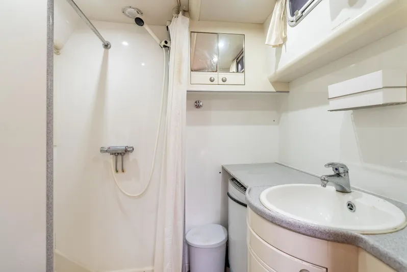 Luka Yacht Photos Pics Bathroom interior of 1997 Farr 60 Pilot House yacht, featuring shower and sink.