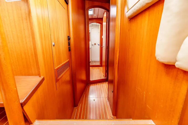 Luka Yacht Photos Pics Interior hallway of 1997 Farr 60 Pilot House yacht with wooden paneling.