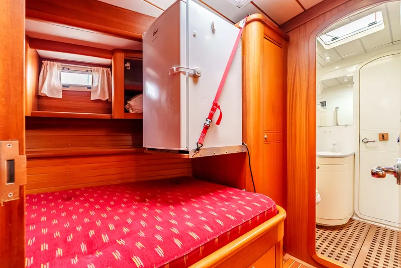 Luka Yacht Photos Pics Cozy cabin interior of 1997 Farr 60 Pilot House with red bedding and compact amenities.