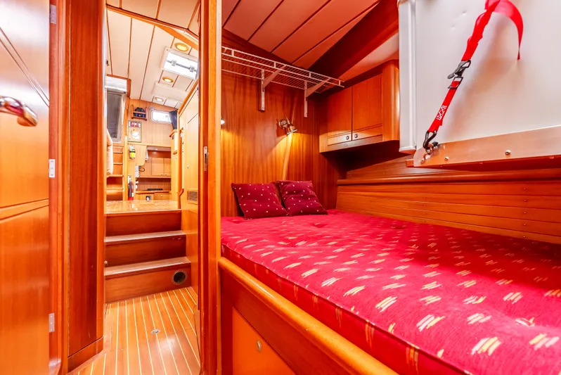 Luka Yacht Photos Pics Cozy cabin interior of 1997 Farr 60 Pilot House with red bedding and wooden finish.