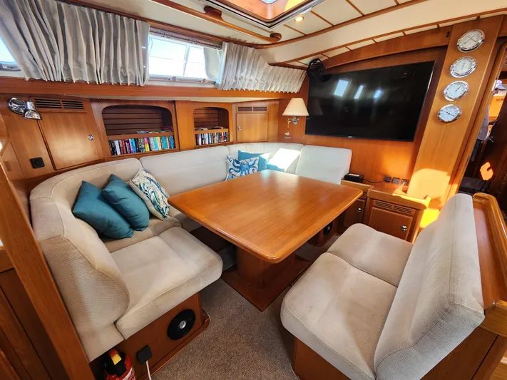 Bonnefooi Yacht Photos Pics Luxurious 2008 Hallberg-Rassy 62 yacht interior with cozy seating and elegant wooden table.