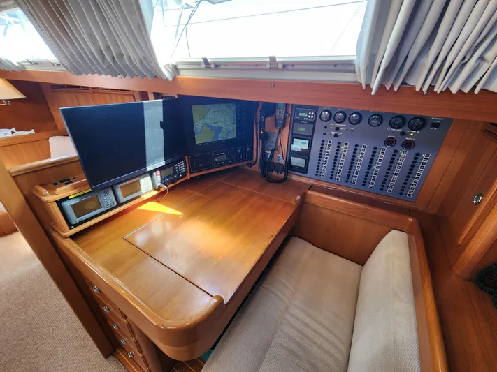 Bonnefooi Yacht Photos Pics Navigation station of 2008 Hallberg-Rassy 62 yacht with control panels and monitors.