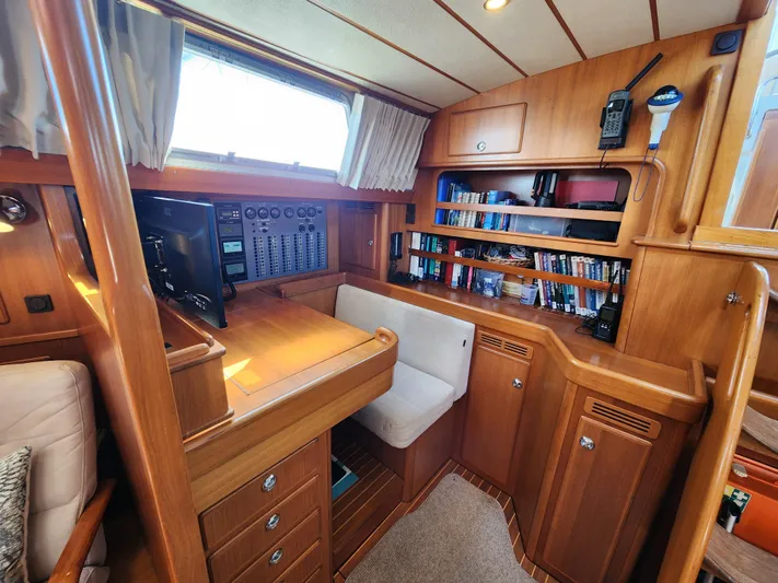 Bonnefooi Yacht Photos Pics Interior of 2008 Hallberg-Rassy 62 yacht with wooden cabinetry and navigation station.
