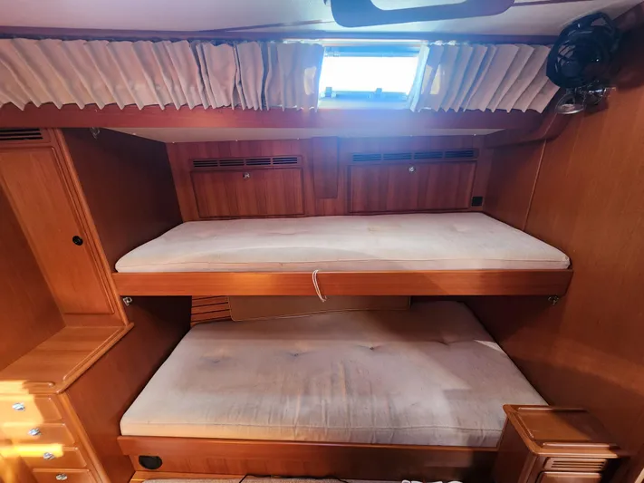 Bonnefooi Yacht Photos Pics Interior of 2008 Hallberg-Rassy 62 yacht with wooden bunk beds and window.