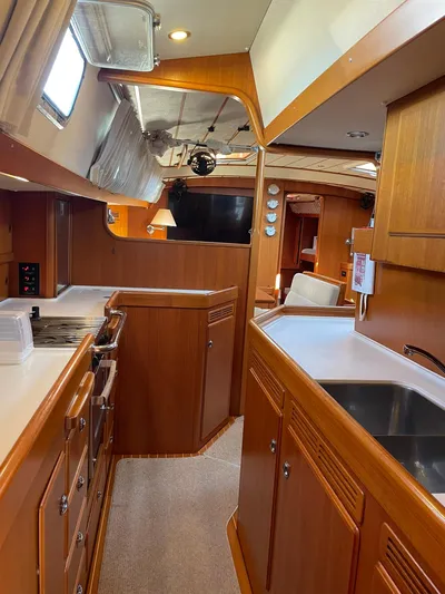 Bonnefooi Yacht Photos Pics Interior of 2008 Hallberg-Rassy 62 yacht, featuring a well-equipped kitchen and wooden cabinetry.