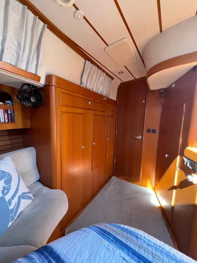 Bonnefooi Yacht Photos Pics Interior of 2008 Hallberg-Rassy 62 yacht with wooden cabinetry and cozy seating.