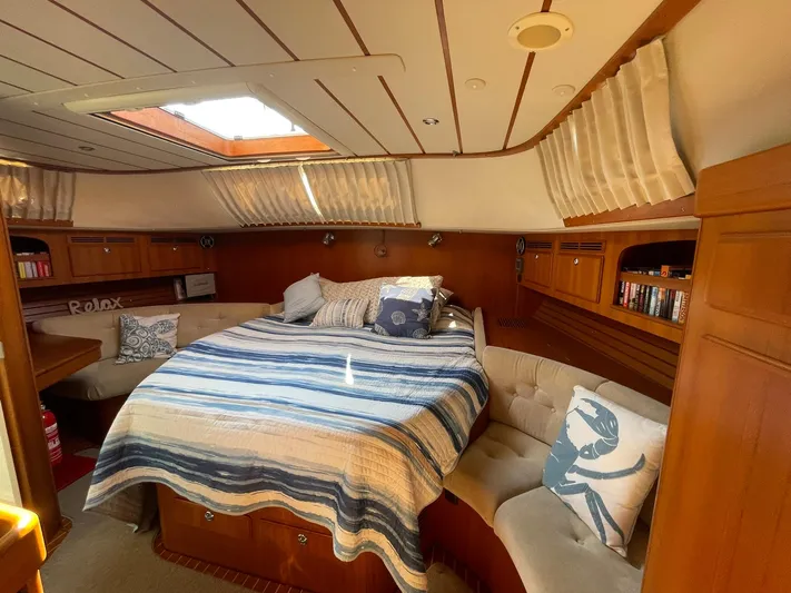Bonnefooi Yacht Photos Pics Luxurious 2008 Hallberg-Rassy 62 yacht cabin with cozy bed and elegant wood finish.