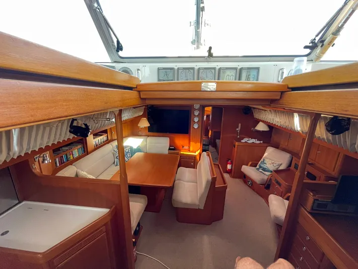 Bonnefooi Yacht Photos Pics Interior of 2008 Hallberg-Rassy 62 yacht, featuring cozy seating and wooden finishes.