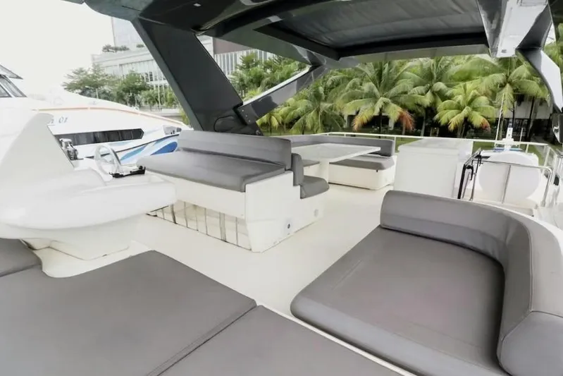  Yacht Photos Pics Luxurious 2017 Ferretti Yachts 700 deck with modern seating and tropical backdrop.