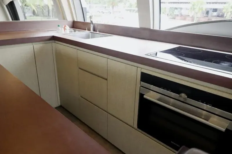  Yacht Photos Pics Modern kitchen interior on 2017 Ferretti Yachts 700, featuring sleek cabinetry and appliances.