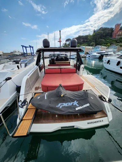  Yacht Photos Pics 2022 Cranchi A46 Luxury Tender docked with Sea-Doo Spark jet ski on deck.