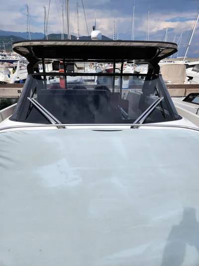  Yacht Photos Pics 2022 Cranchi A46 Luxury Tender docked at marina, showcasing sleek design and windshield.