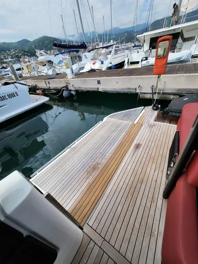  Yacht Photos Pics 2022 Cranchi A46 Luxury Tender docked at marina, showcasing elegant wooden deck.