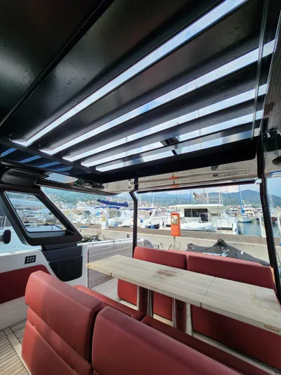  Yacht Photos Pics Interior of 2022 Cranchi A46 Luxury Tender with red seating and marina view.