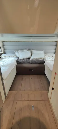  Yacht Photos Pics Interior cabin of 2022 Cranchi A46 Luxury Tender with cozy bedding and modern design.