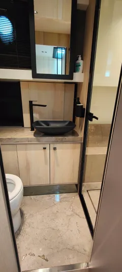  Yacht Photos Pics Luxurious bathroom in 2022 Cranchi A46 Luxury Tender with modern fixtures and elegant design.