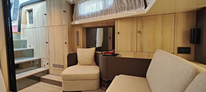  Yacht Photos Pics Luxurious interior of 2022 Cranchi A46 Luxury Tender with modern seating and cabinetry.