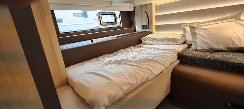  Yacht Photos Pics Interior cabin of 2022 Cranchi A46 Luxury Tender with cozy bedding and modern design.