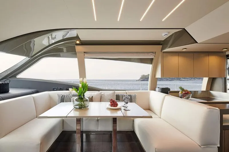  Yacht Photos Pics Luxurious interior of 2022 Ferretti Yachts 550 with elegant seating and ocean view.