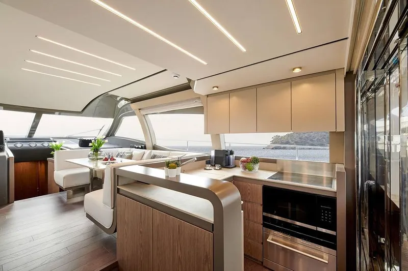  Yacht Photos Pics Luxurious interior of 2022 Ferretti Yachts 550 with modern kitchen and seating area.