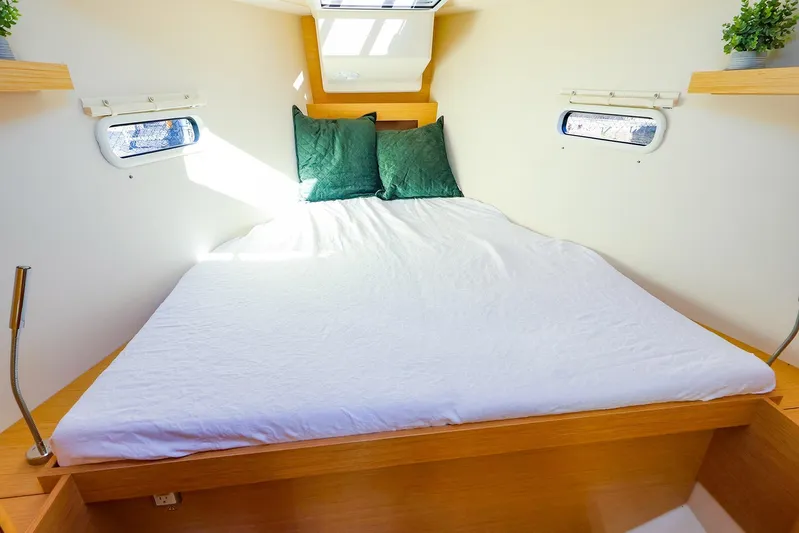  Yacht Photos Pics Cozy cabin interior of 2022 Hanse 388 yacht with double bed and porthole windows.