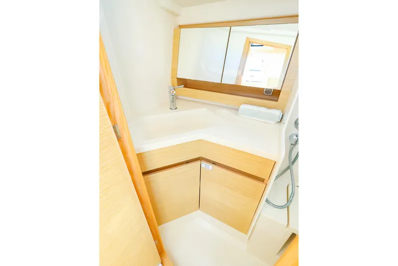  Yacht Photos Pics Modern bathroom interior of 2022 Hanse 388 yacht with sleek design and wooden accents.
