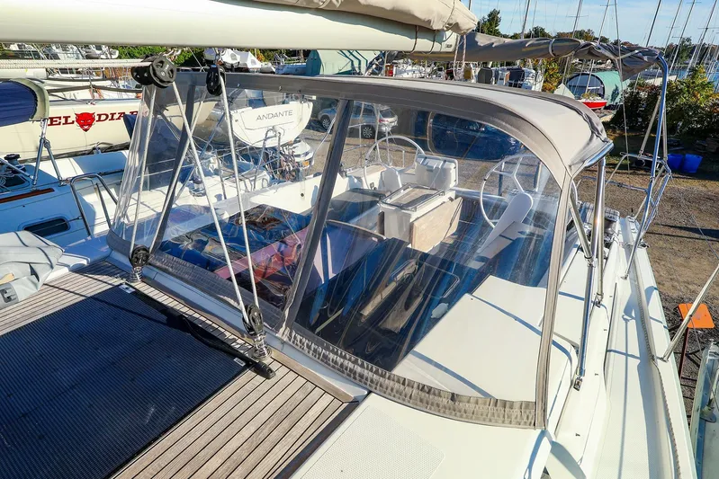  Yacht Photos Pics 2022 Hanse 388 sailboat with cockpit cover, docked in a marina.