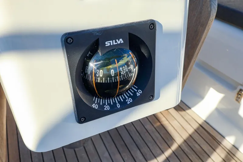  Yacht Photos Pics Compass on 2022 Hanse 388 yacht, displaying navigation degrees, mounted on wooden deck.