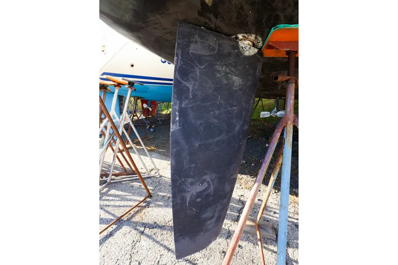  Yacht Photos Pics Hanse 388 sailboat keel, 2022 model, supported on stands in a boatyard.