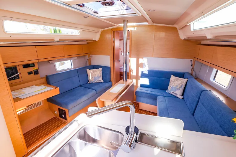  Yacht Photos Pics Luxurious interior of 2022 Hanse 388 yacht with blue seating and modern amenities.