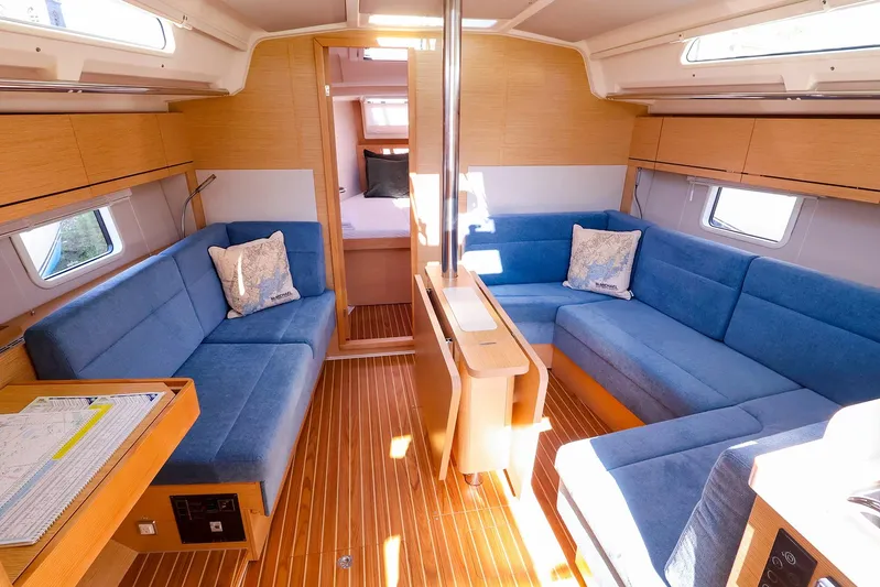  Yacht Photos Pics Interior of 2022 Hanse 388 yacht with blue seating and wooden accents.