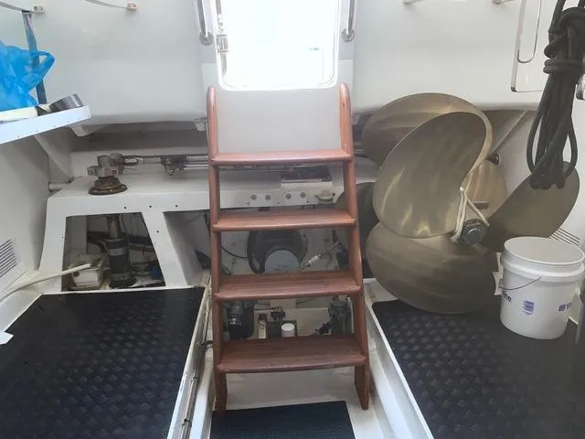 Maverick Yacht Photos Pics Engine room of a 2008 Hampton Command Bridge yacht with wooden steps and large propellers.