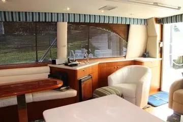 Island Dancer Yacht Photos Pics Interior of a 1996 Ocean 53 Super Sport yacht with elegant seating and wood finishes.