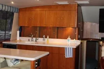 Island Dancer Yacht Photos Pics Interior of 1996 Ocean 53 Super Sport yacht with wooden cabinetry and modern kitchen amenities.