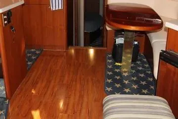 Island Dancer Yacht Photos Pics Interior of a 1996 Ocean 53 Super Sport yacht with wooden flooring and star-patterned carpet.