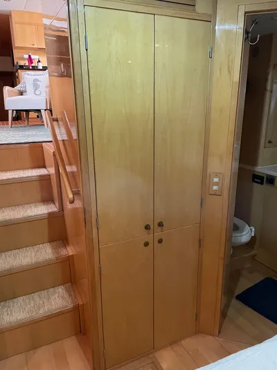 Hydrotherapy Yacht Photos Pics Wooden interior of 1999 Jefferson 52 Rivanna Aft Cabin yacht, featuring stairs and closet.