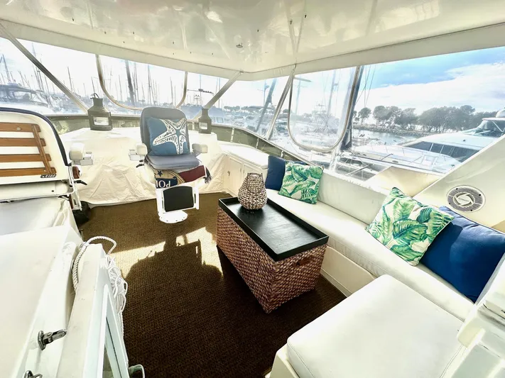 Hydrotherapy Yacht Photos Pics Aft cabin interior of 1999 Jefferson 52 Rivanna, featuring seating and nautical decor.