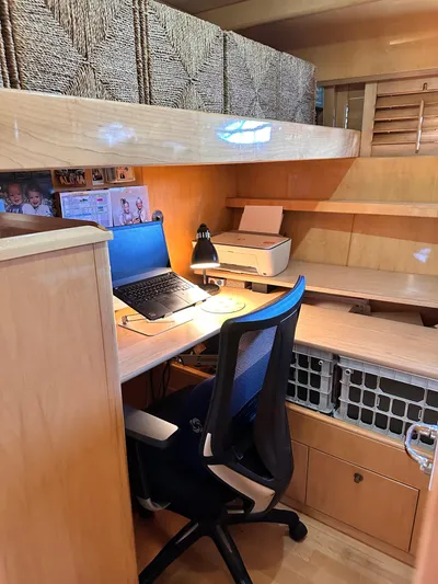 Hydrotherapy Yacht Photos Pics Office setup inside 1999 Jefferson 52 Rivanna Aft Cabin yacht with desk, chair, and laptop.