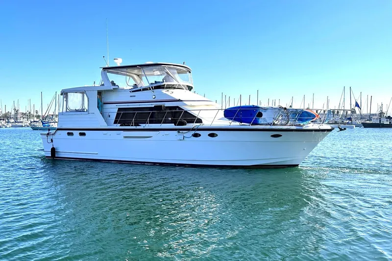 Hydrotherapy Yacht Photos Pics 1999 Jefferson 52 Rivanna Aft Cabin yacht on calm water, marina background.