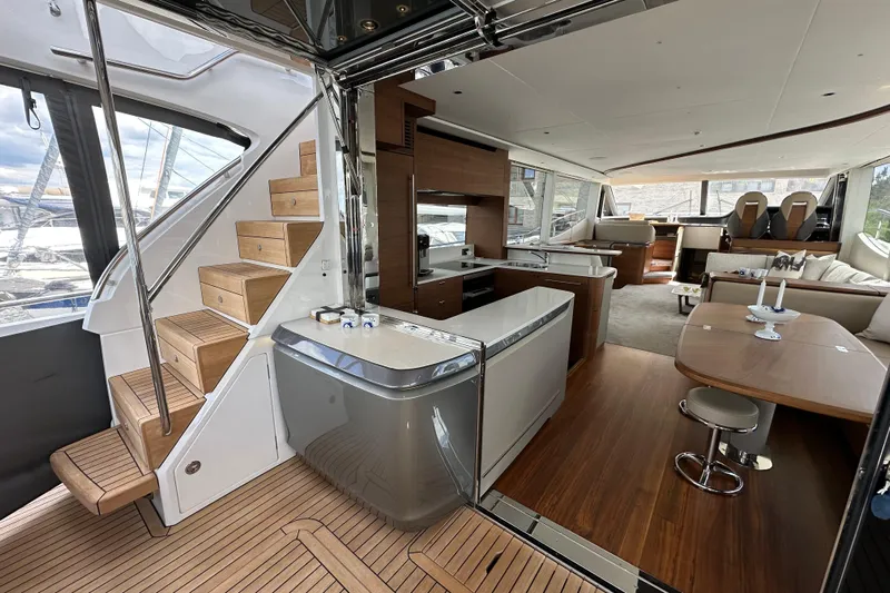  Yacht Photos Pics Luxurious interior of 2022 Princess Y72 yacht with modern kitchen and seating area.