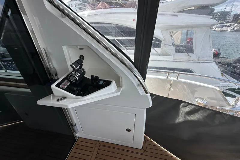  Yacht Photos Pics Control panel on 2022 Princess Y72 yacht, overlooking marina with luxury boats.