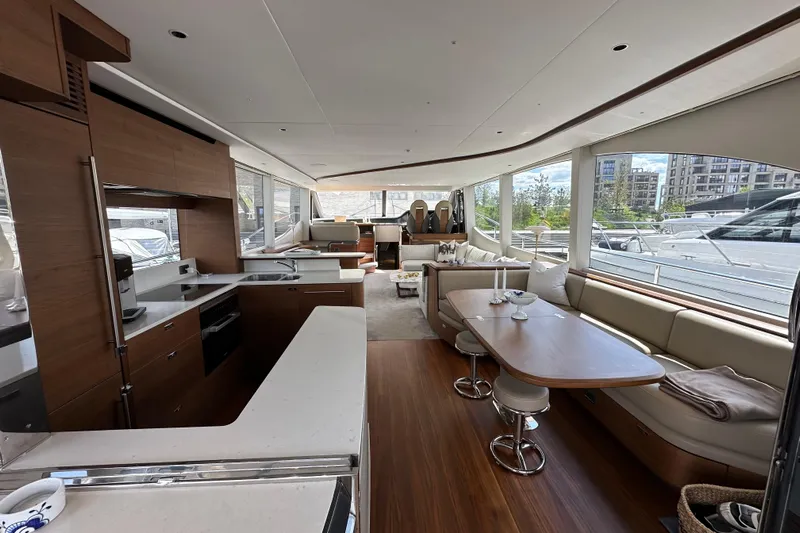  Yacht Photos Pics Luxurious interior of 2022 Princess Y72 yacht with modern kitchen and spacious seating area.
