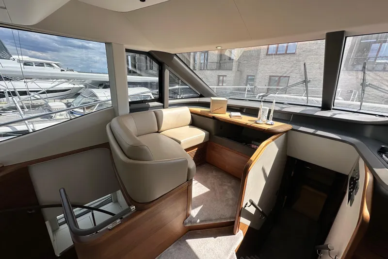  Yacht Photos Pics Luxurious interior of 2022 Princess Y72 yacht with elegant seating and panoramic windows.
