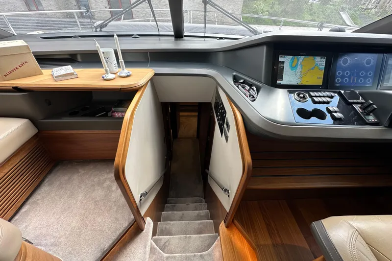  Yacht Photos Pics Interior of 2022 Princess Y72 yacht with navigation controls and elegant wood finish.