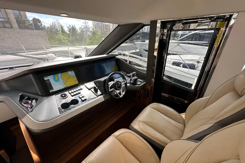  Yacht Photos Pics Luxurious 2022 Princess Y72 yacht cockpit with modern navigation system and plush seating.