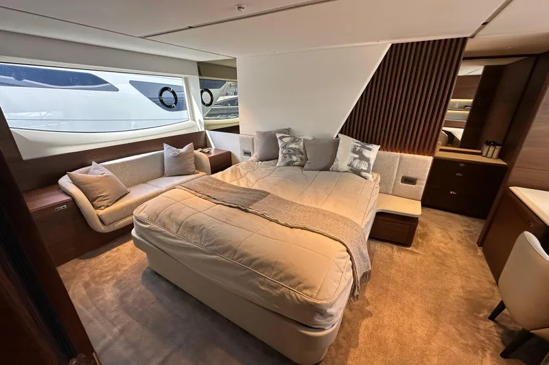  Yacht Photos Pics Luxurious 2022 Princess Y72 yacht bedroom with elegant decor and large windows.